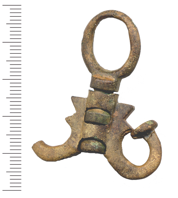 An incomplete copper alloy suspension swivel for an oil flask. The swivel is 43 mm in length and 39.5mm wide with a sub-circular suspension loop 18.5 x15.5 mm in diameter that is quite worn upon its i