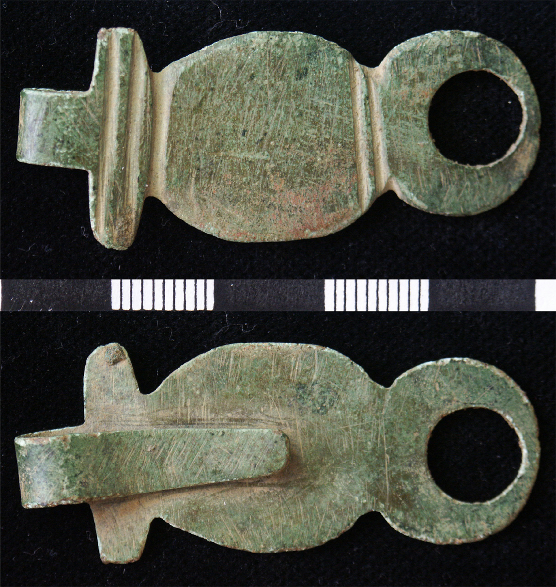 Medieval hooked suspension mount from belt, cut from sheet and comprising a narrowed projection at apex, folded onto reverse to form a clip to hook onto a belt, springing from a grooved transverse exp