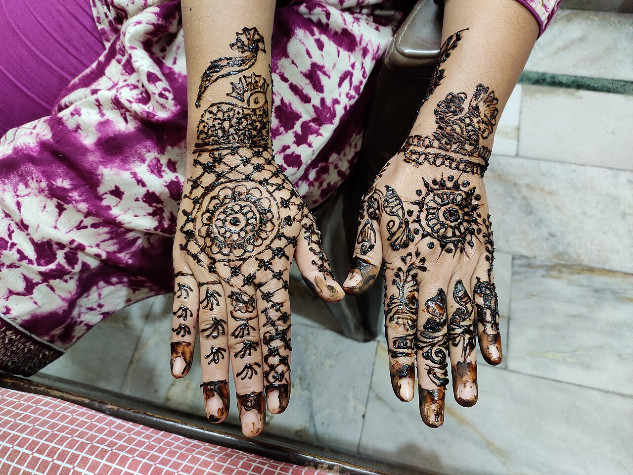 This is traditional henna art done in India during many occasions. This strains the hand after leaving for some time and remains for few days as a temporary tattoo.
