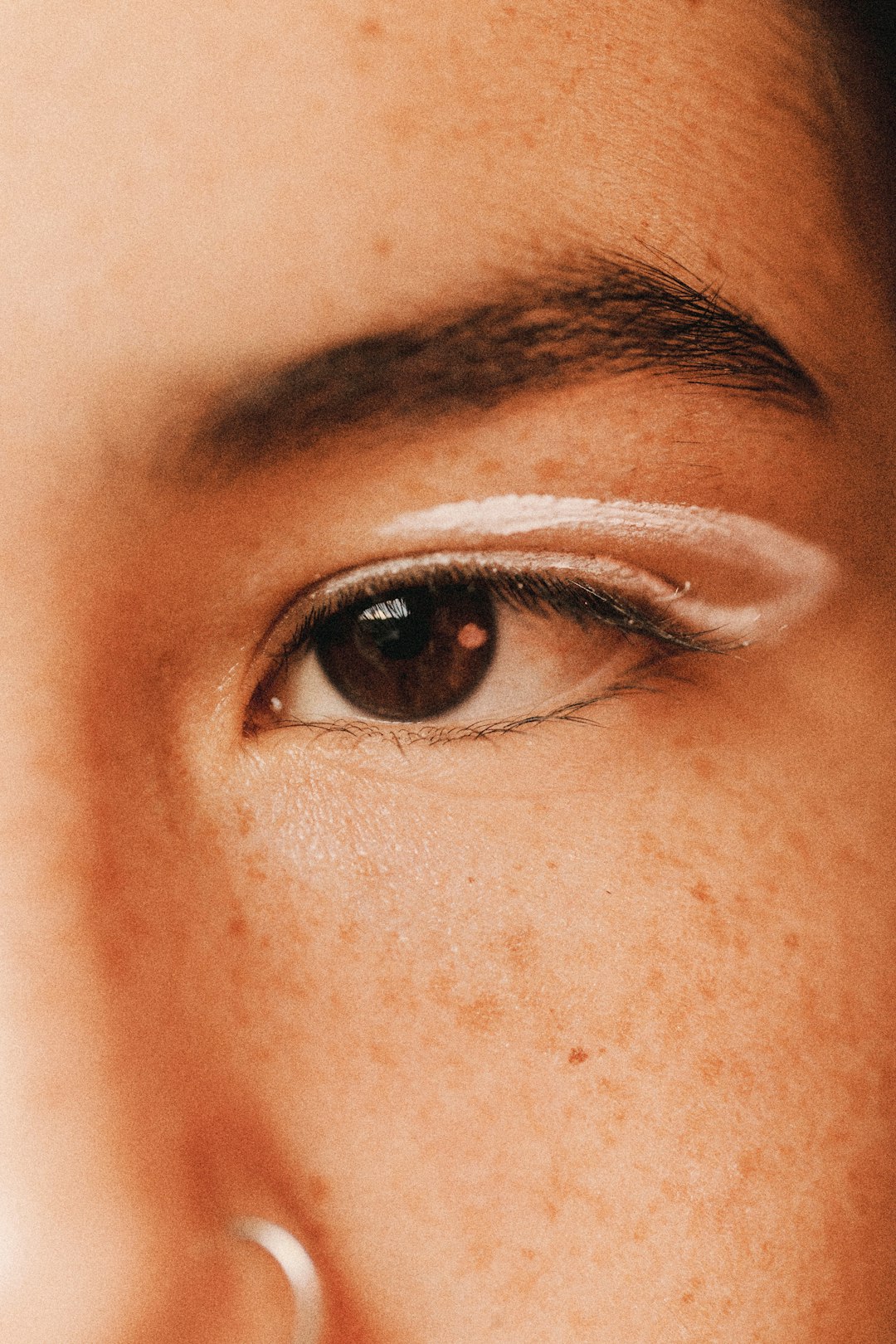 Eye with white makeup.