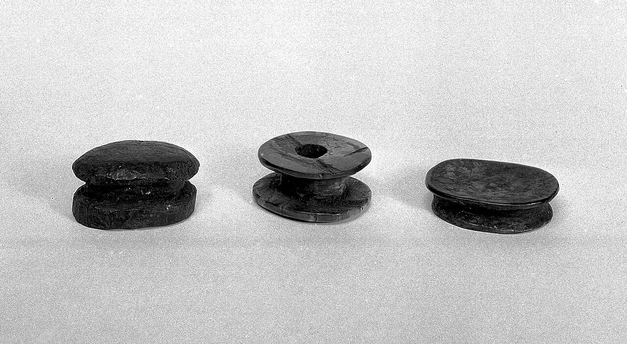 1. Labret (lip plug), bone, elliptical, grooved, upper surface convex, Haida, N.W. coast of America.2. Labret (lip plug), bone, elliptical, grooved, all surfaces concave. Haida, Queen Charlotte Islan