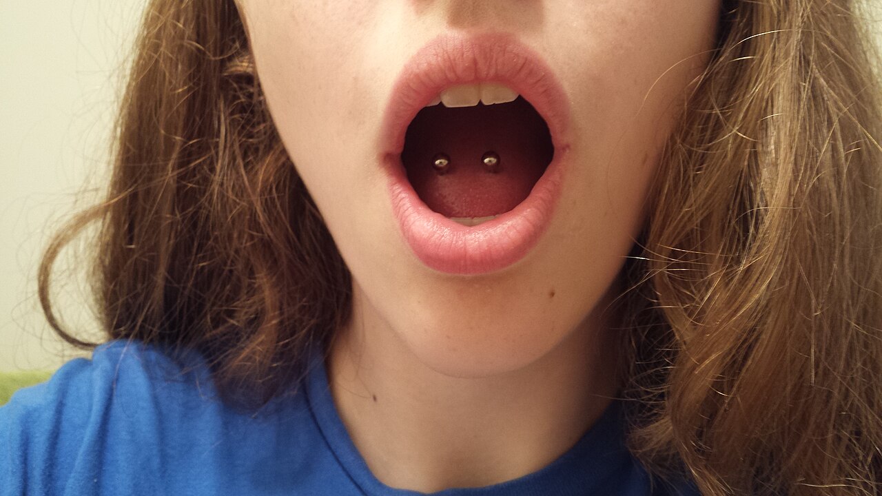 Double tongue piercings placed side-by-side horizontally. These are healed.