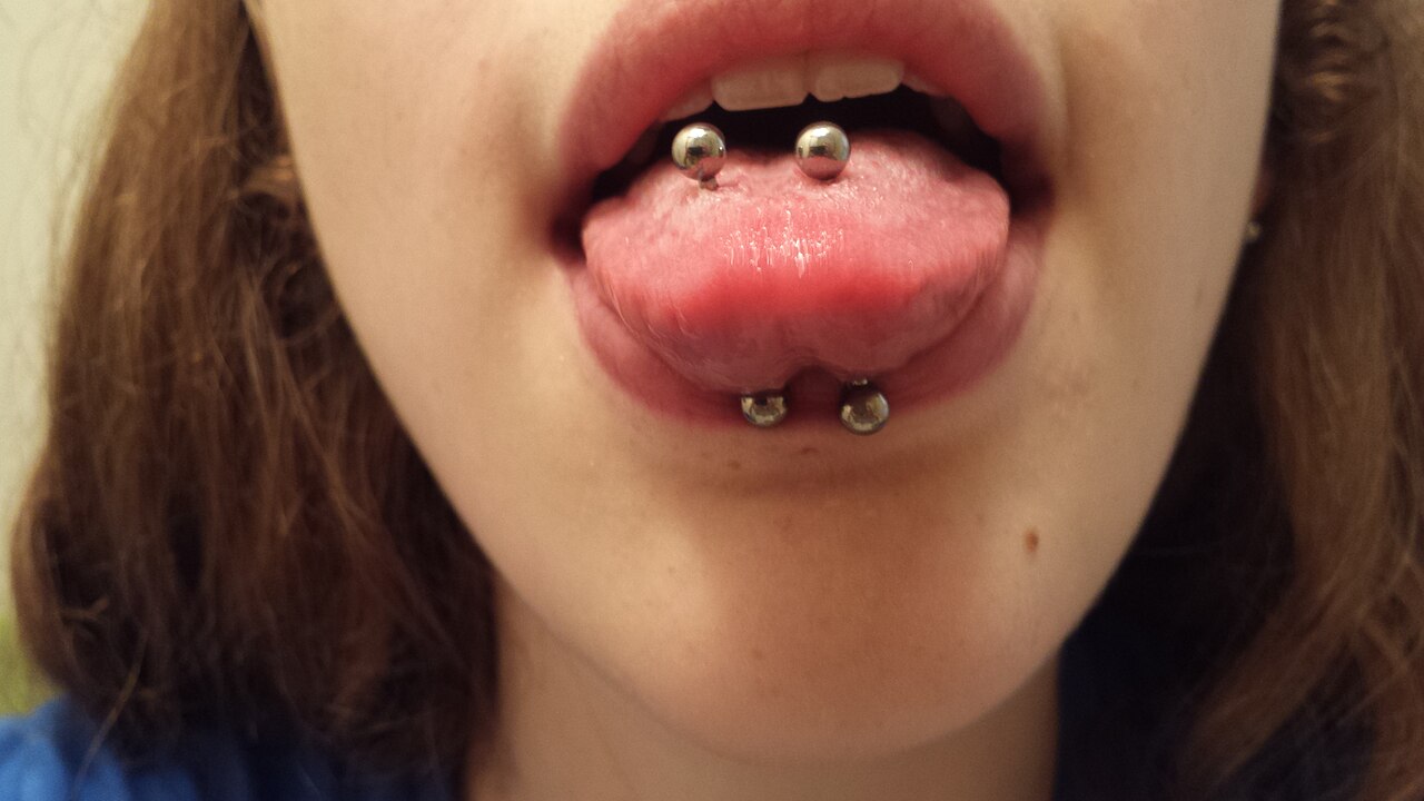 Photograph of healed venom piercings, showing that they are two separate piercings