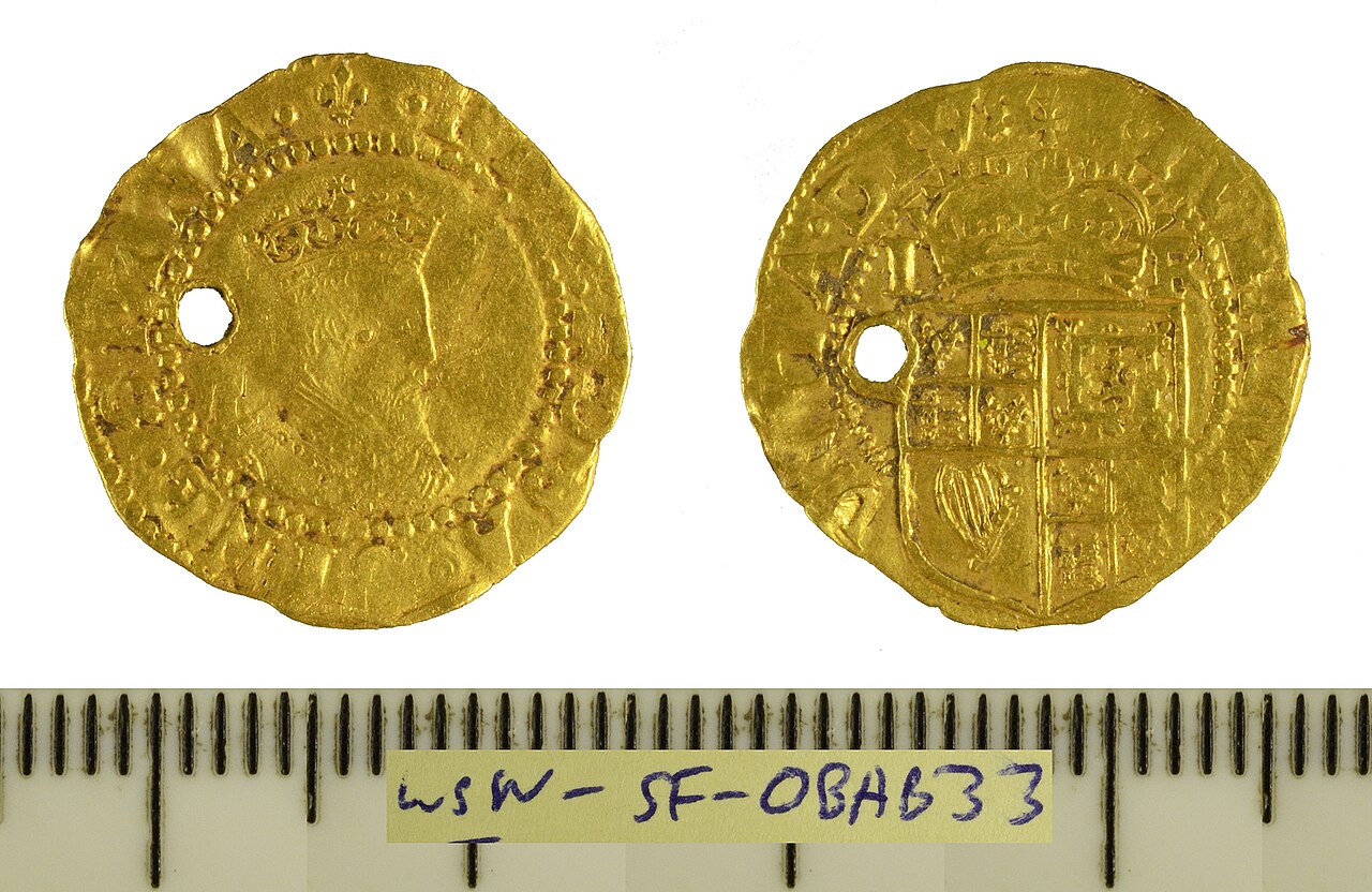 A gold hammered halfcrown struck for James I, dating c. 1623-1624. Tower mint, Third coinage, initial mark: lis. As North 2093.This coin demonstrates a circular piercing directly behind the bust, in