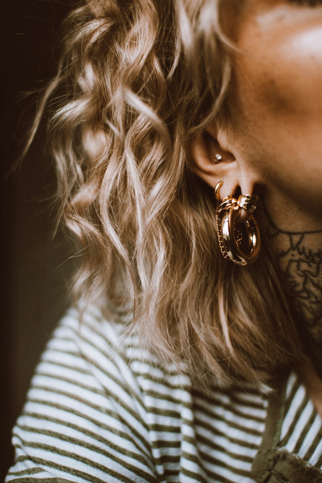 a close up of a person wearing a pair of earrings