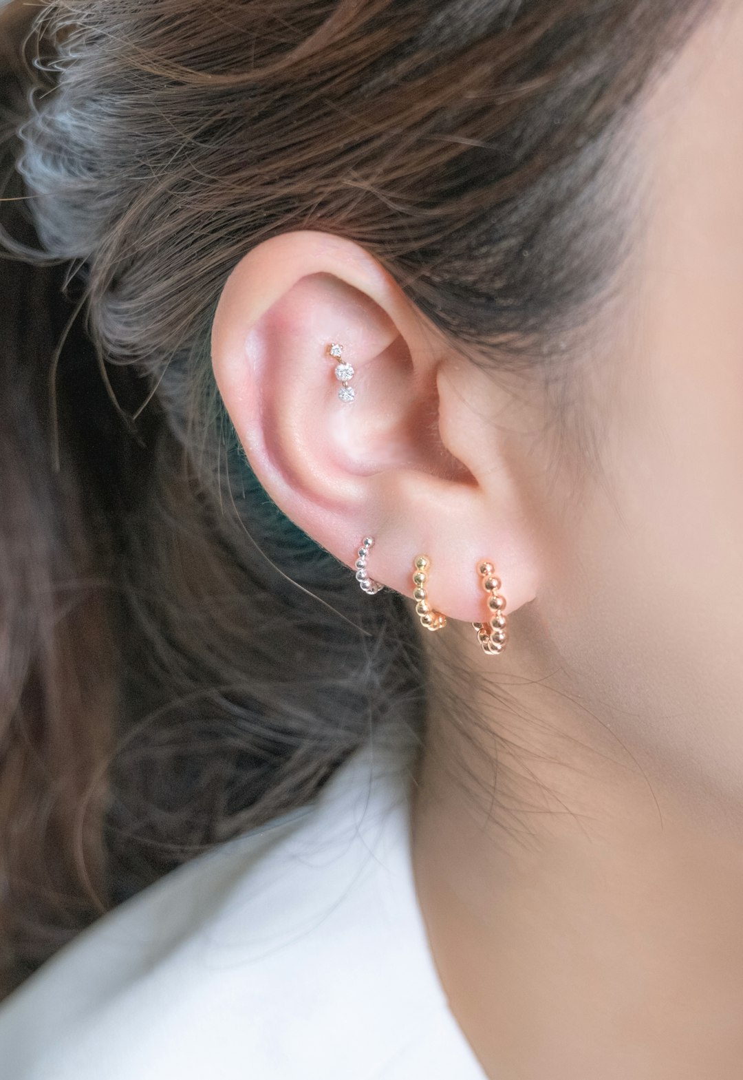 The Donut Huggies are a playful yet elegant addition to any jewelry collection. Crafted from solid 14k gold, these earrings feature a charming donut shape that wraps comfortably around the earlobe. Perfect for everyday wear, they embody a delightful