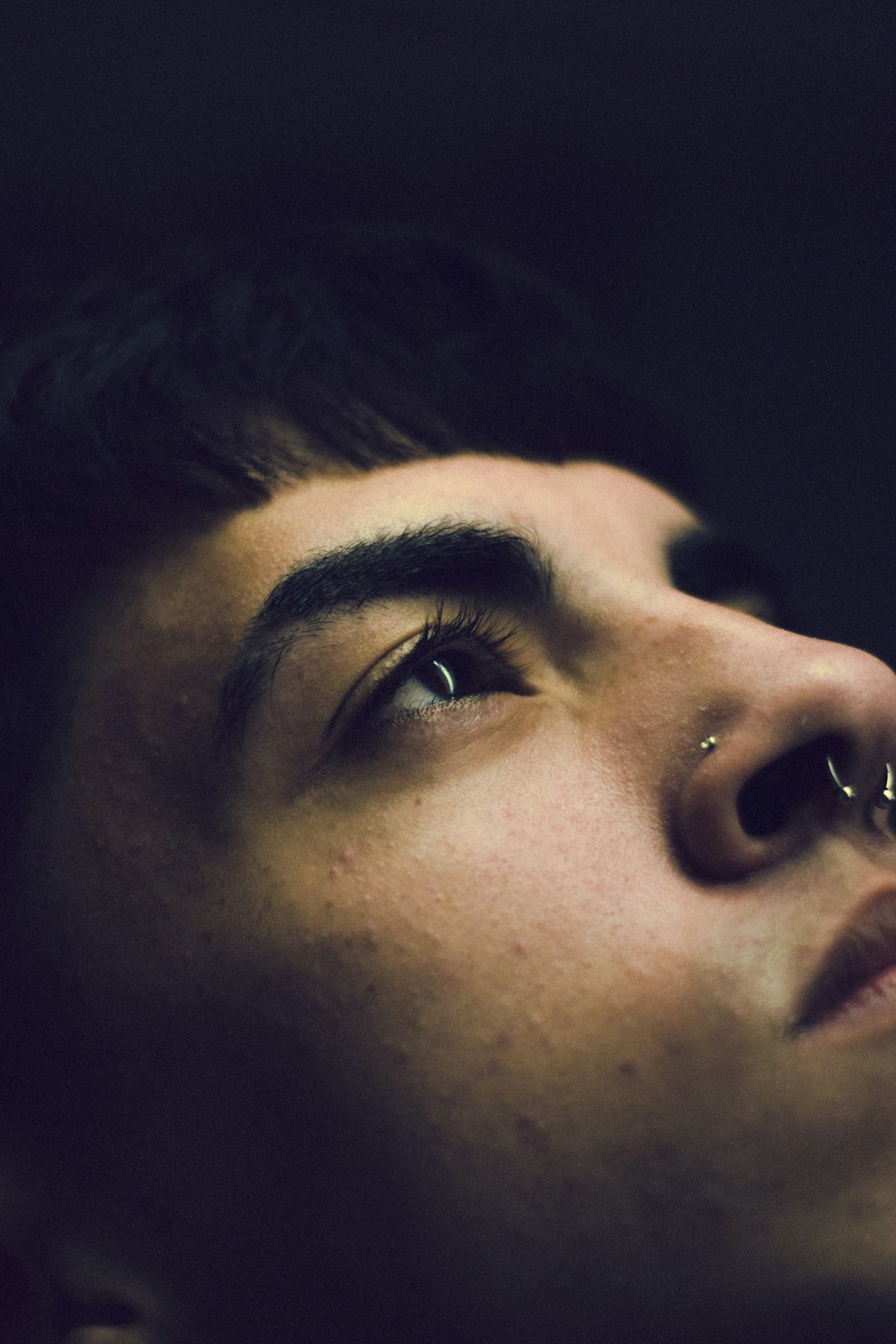 a close up of a person with a nose piercing