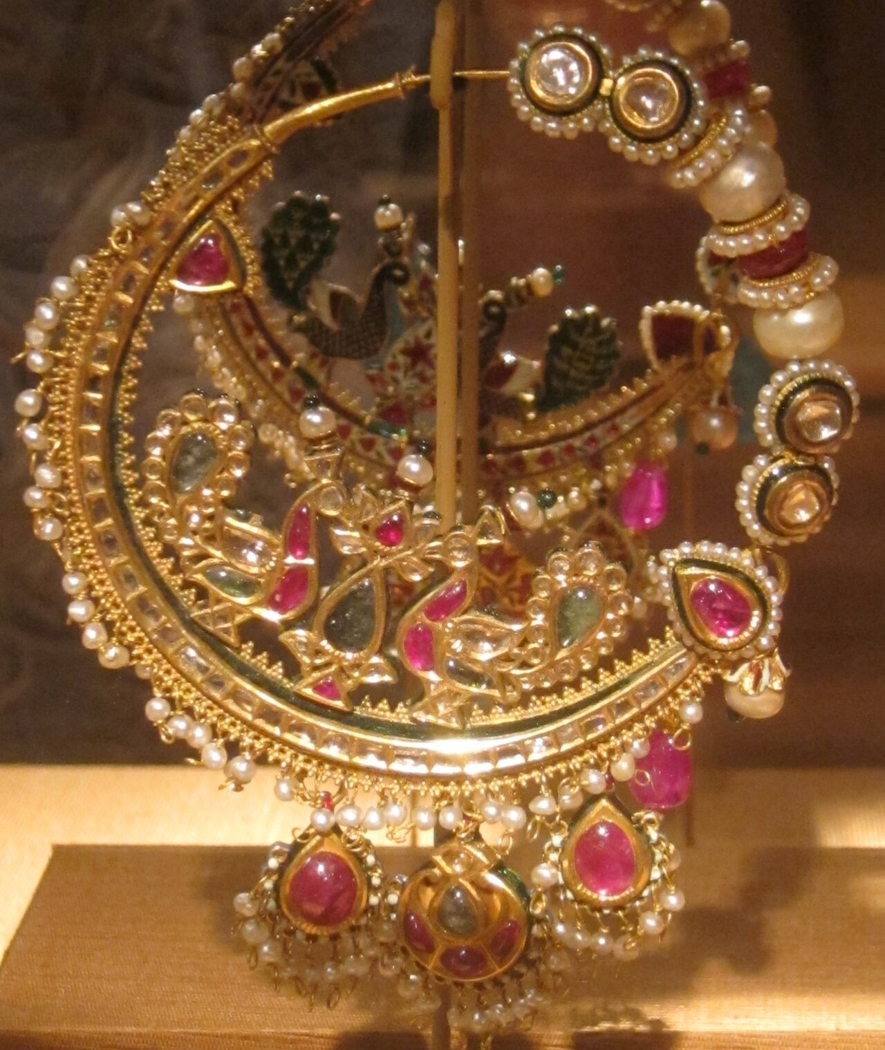 Nose ring, northern India, early 20th century, gold, rubies, emeralds, diamonds, pearls and enamel, on long-term loat to the Honolulu Academy of Arts