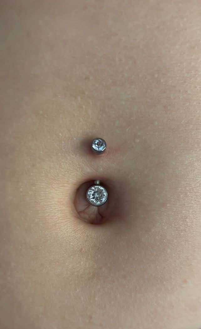 A barbell navel jewellery in deep navel
