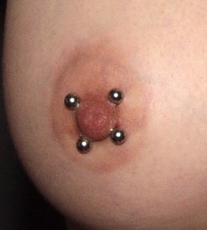 Bella Vendetta has 18 body piercings including double lip, labret, nosering and side stud, tongue, ears, the double nipples (seen here), double clithood, and two vaginal lips. Ten tattoos include shou