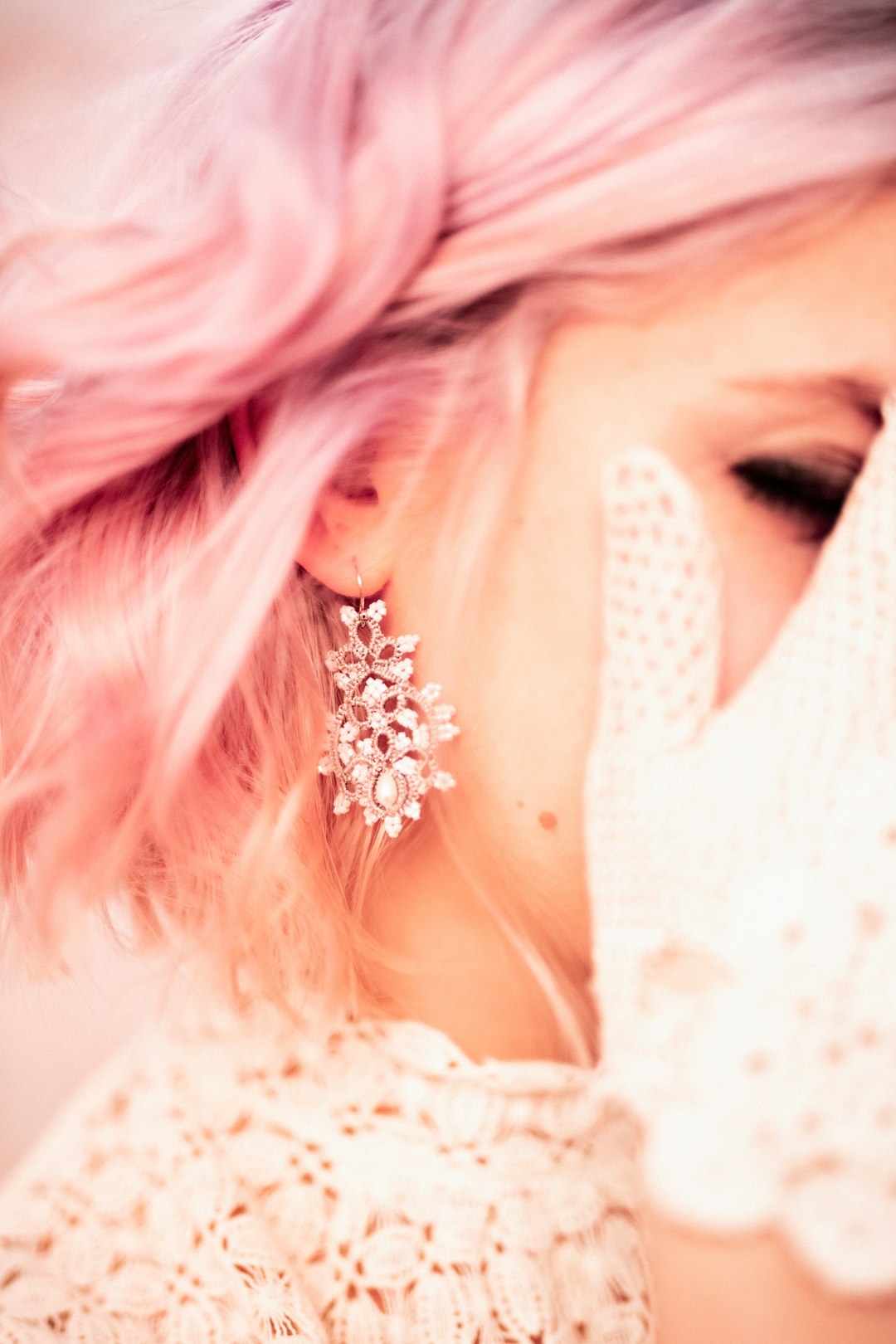 Woman with pink hair and ornate earring