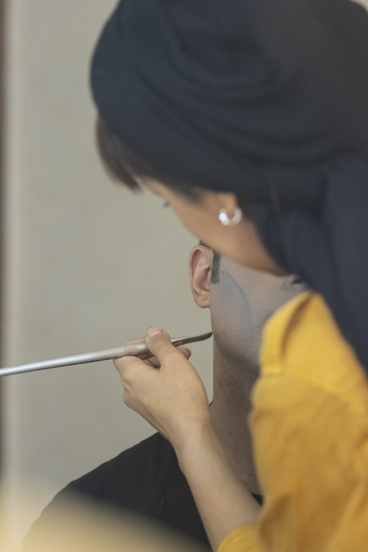 A make-up artist, also called a makeup artist, and often shortened to MUA, is an artist whose medium is the human body, applying makeup and prosthetics on others for theatre, television, film, fashion