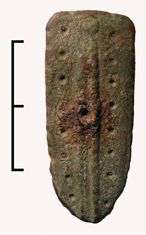 Cast copper alloy strap end of lingulate (tongue shaped) form. Two narrow ribs run down its length either side of which is a row of ring-and-dot motifs.The bifurcation survives and through it is a sin