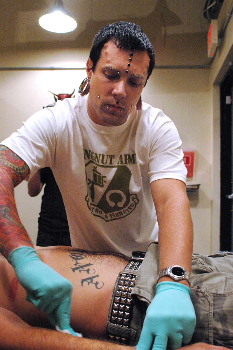 Post preps, sterilizes and marks each area before piercing. Joel Wirz of Good Clean Fun in Monticello assisted.