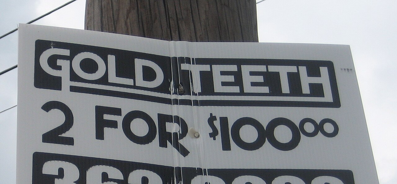 New Orleans: Sign on pole in Mid-City advertising 2 gold teeth. Doesn't say if they are new or used.
